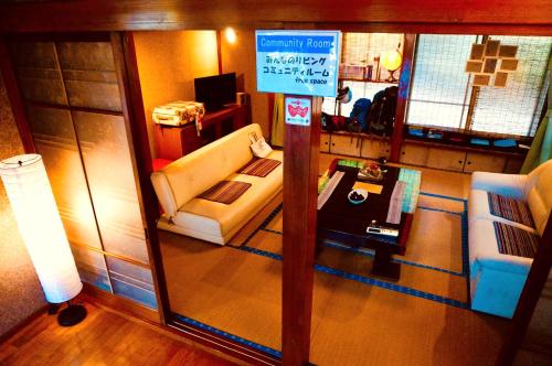 a view of a living room with a couch and a sign at Matakitai in Ichinoseki
