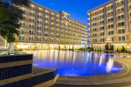 a large building with a large pool in front of it at LK Celestite in Pattaya South