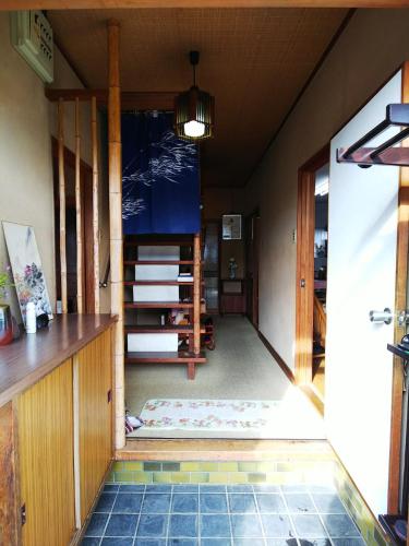 a hallway of a house with a door and a floor at Ikkenya Kitagata in Okayama