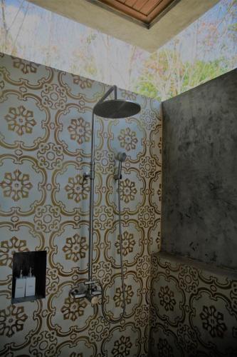 a bathroom with a shower in a room with a wallpaper at Mook Lamai Resort and Spa in Ko Mook