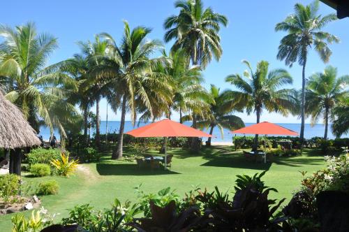 a view of a resort with palm trees and the ocean at Nukubati Great Sea Reef in Nukubati