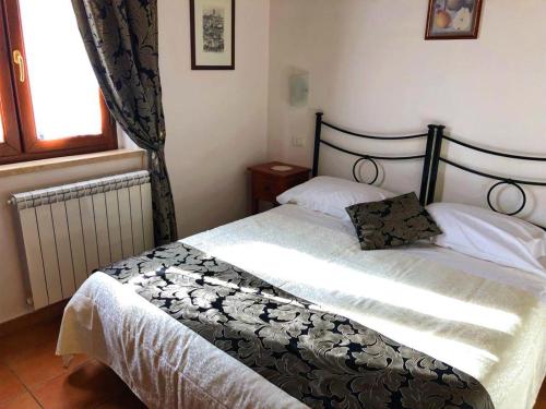a bedroom with two beds and a window at Villa Tuscany Siena in Siena