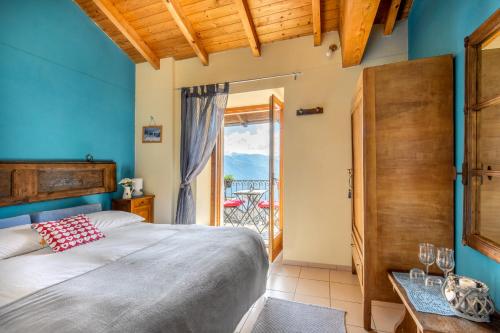 a bedroom with a bed and a door to a balcony at Agriturismo Da Attilio in Cannobio