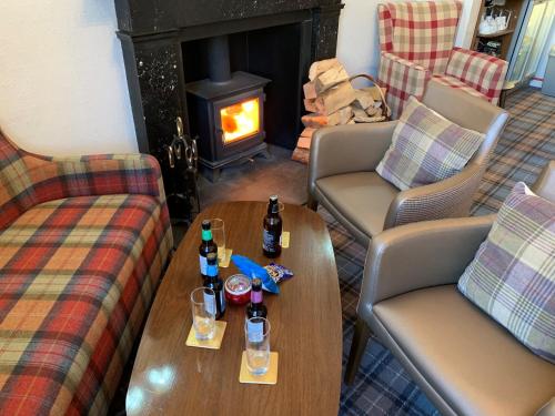 a living room with couches and a table with drinks on it at The Albany St Andrews in St. Andrews