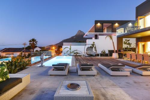a villa with a swimming pool and a house at Jo Leo House by Totalstay in Cape Town