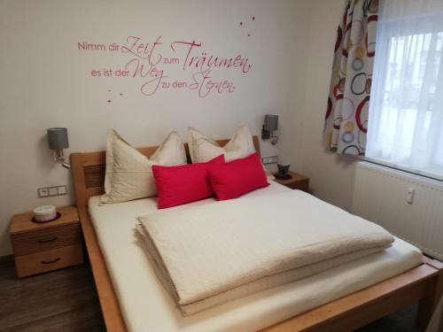 a bedroom with a bed with red pillows at Schmaranzer in Bad Ischl