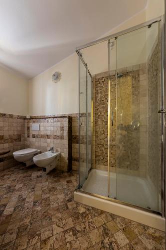 a bathroom with a shower and a toilet and a sink at Sardinia for you in Oristano