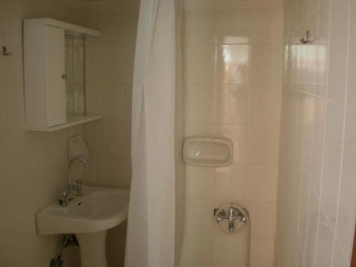 a bathroom with a shower curtain and a sink at Pentari in Stalos