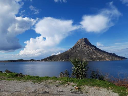 a mountain in the middle of a body of water at Avra Studios in Masouri