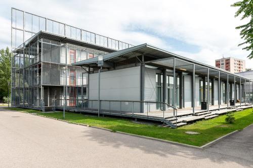 a building with a glass facade on a street at Orange Wings Krems in Krems an der Donau