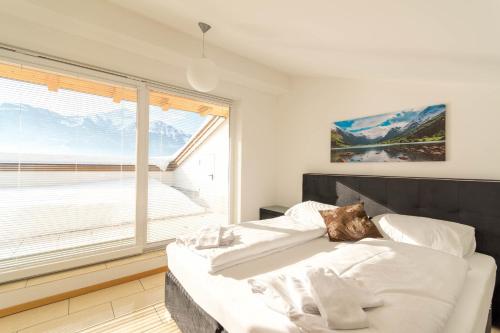 Posteľ alebo postele v izbe v ubytovaní Ski-n-Lake - The Alps View Apartment
