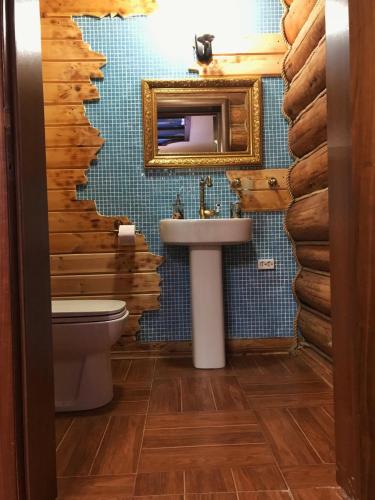 a bathroom with a sink and a mirror at Holiday House Karavella in Abzakovo