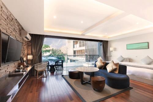 a living room with a couch and a table at Suites by Watermark Hotel and Spa in Jimbaran