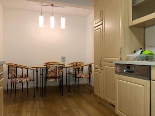 a kitchen with a table and chairs in a room at Clean&Comfort Apartments Near Hannover Fairgrounds in Hannover