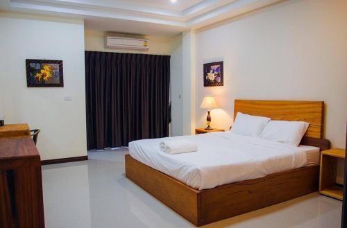 ein Schlafzimmer mit einem großen Bett in einem Zimmer in der Unterkunft Baan Kiang Wang in Phetchaburi