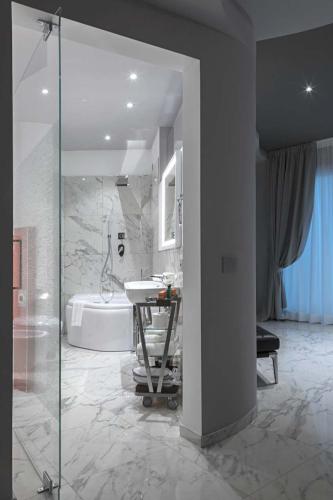 a bathroom with a shower and a sink and a tub at Borgo San Barbato in Lavello