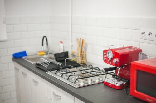 a red mixer sitting on top of a kitchen counter at Apartament Elena in Târgu-Mureş