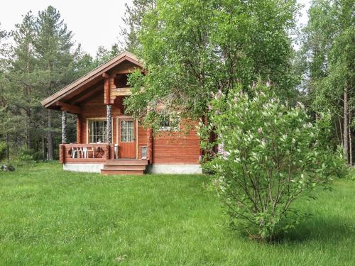 a small log cabin in a field of grass at Holiday Home Anula by Interhome in Sodankylä