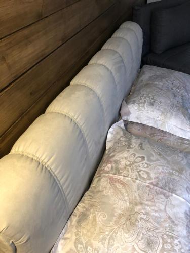 a row of pillows sitting on a bed at Girske Povitria 2 in Yaremche