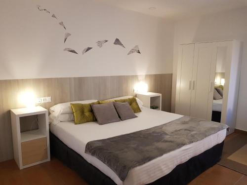 a bedroom with a large bed with birds on the wall at Campomar Playa in El Puerto de Santa María