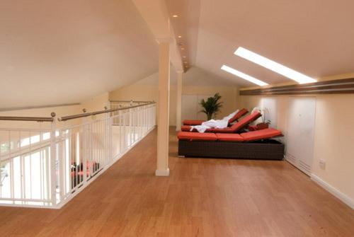 a living room with a couch and a staircase at Parkhotel am Taunus in Oberursel
