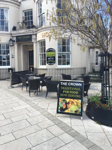 a sign on a sidewalk in front of a building at The Crown Hotel in Ryde