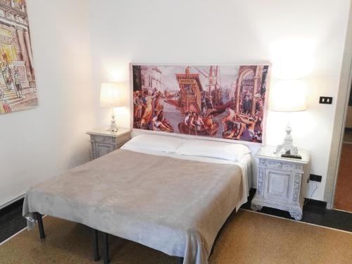 a bedroom with a bed with a painting on the wall at Fornaro Apartments in Genoa