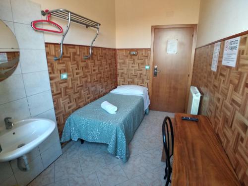 a small room with a bed and a sink at Cressy in Rome