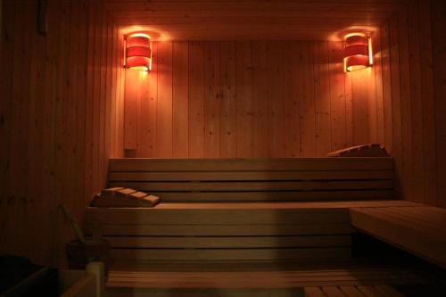 a sauna with a bench and lights on the wall at Rooms Centar in Delnice