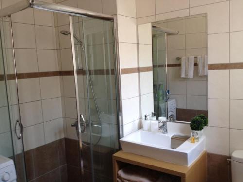 a bathroom with a sink and a shower at Villa Anna in Pefki Rhodes