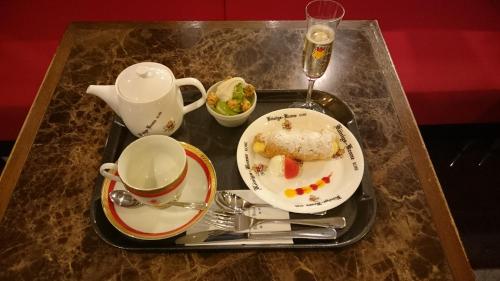a tray with a plate of food and a tea set on a table at Hotel Konigs-Krone Kobe in Kobe