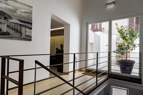 a staircase in a house with a potted plant at Le Maestranze Deluxe Rooms in Sciacca