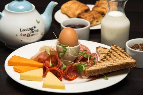 a plate of food with an egg and vegetables and bread at The Wesley Euston in London