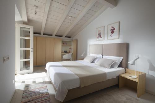 a bedroom with a large white bed with white pillows at Villa Orti in Dubrovnik