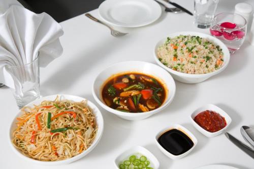 a white table topped with bowls of food and rice at Springs Hotels and Spa in Bengaluru
