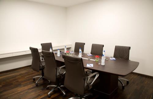 a conference room with a long table and chairs at Springs Hotels and Spa in Bengaluru