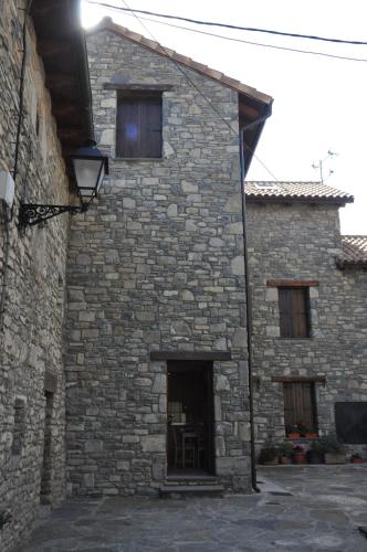 a stone building with a door and windows at Casa Rural Cancias in Fiscal