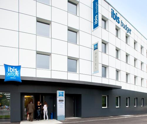 a white building with people standing outside of it at ibis budget Genève Petit-Lancy in Geneva