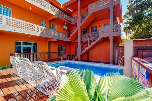 a swimming pool in front of a house at Hummingbird Home Suites in San Pedro