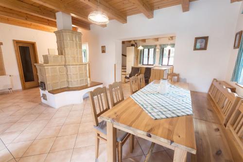 a dining room with a table and a wood stove at Holiday House Vitice 21 in Vitice