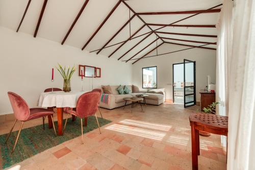 a living room with a table and chairs at Open Air Historic Penthouse Vegueta in Las Palmas de Gran Canaria
