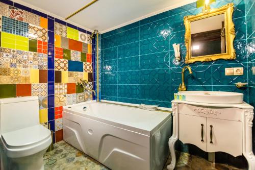 a bathroom with a tub and a toilet and a sink at Tiflis Inn Boutique Hotel in Tbilisi City
