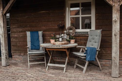 a table and two chairs on a patio at Blauwe Lucht in Deurne