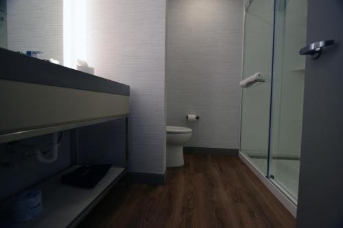a bathroom with a toilet and a glass shower at Legacy Hotel at IMG Academy in Bradenton