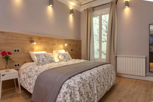a bedroom with a large bed and a window at Suites You Platinum in Madrid