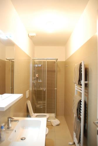 a bathroom with a toilet and a sink and a shower at Como Rooms & Apartments T.10 in Como