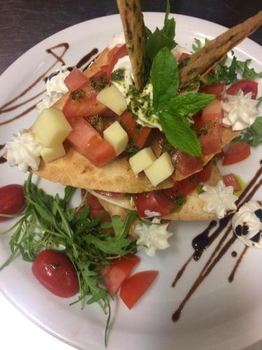a white plate topped with food on top of sidx sidx sidx sidx sidx at Enalion Hotel in Kala Nera