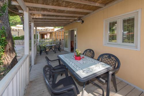 a patio with a table and chairs on a porch at Il Villaggio Di Giuele in Finale Ligure