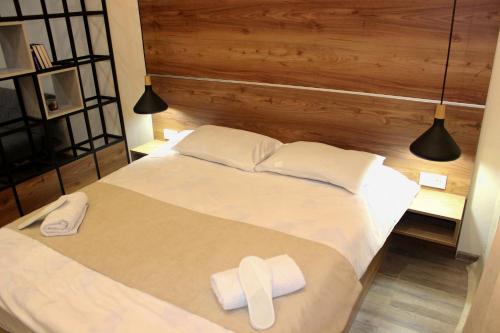 a bedroom with a bed with two white towels on it at Apartment Kutaisi in Kutaisi