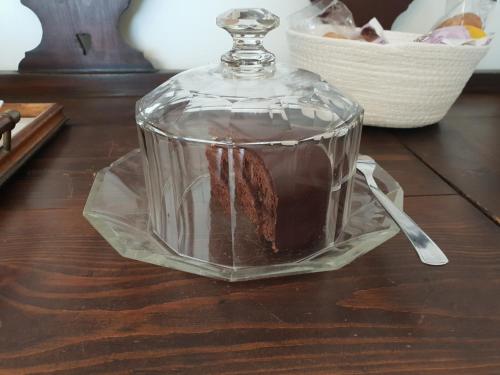 a cake in a glass container on a table at La terrazza di Anna in Sassari